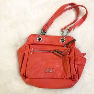 POP of orange hand bag by Tyler Rodan